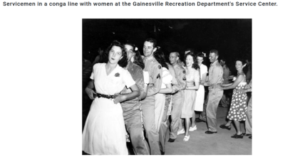 Servicemen dancing in a Conga line